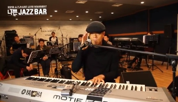 Park Jin Young Sings to Concert Schedule in Latest Promo Video for “Bad Jazz Bar”