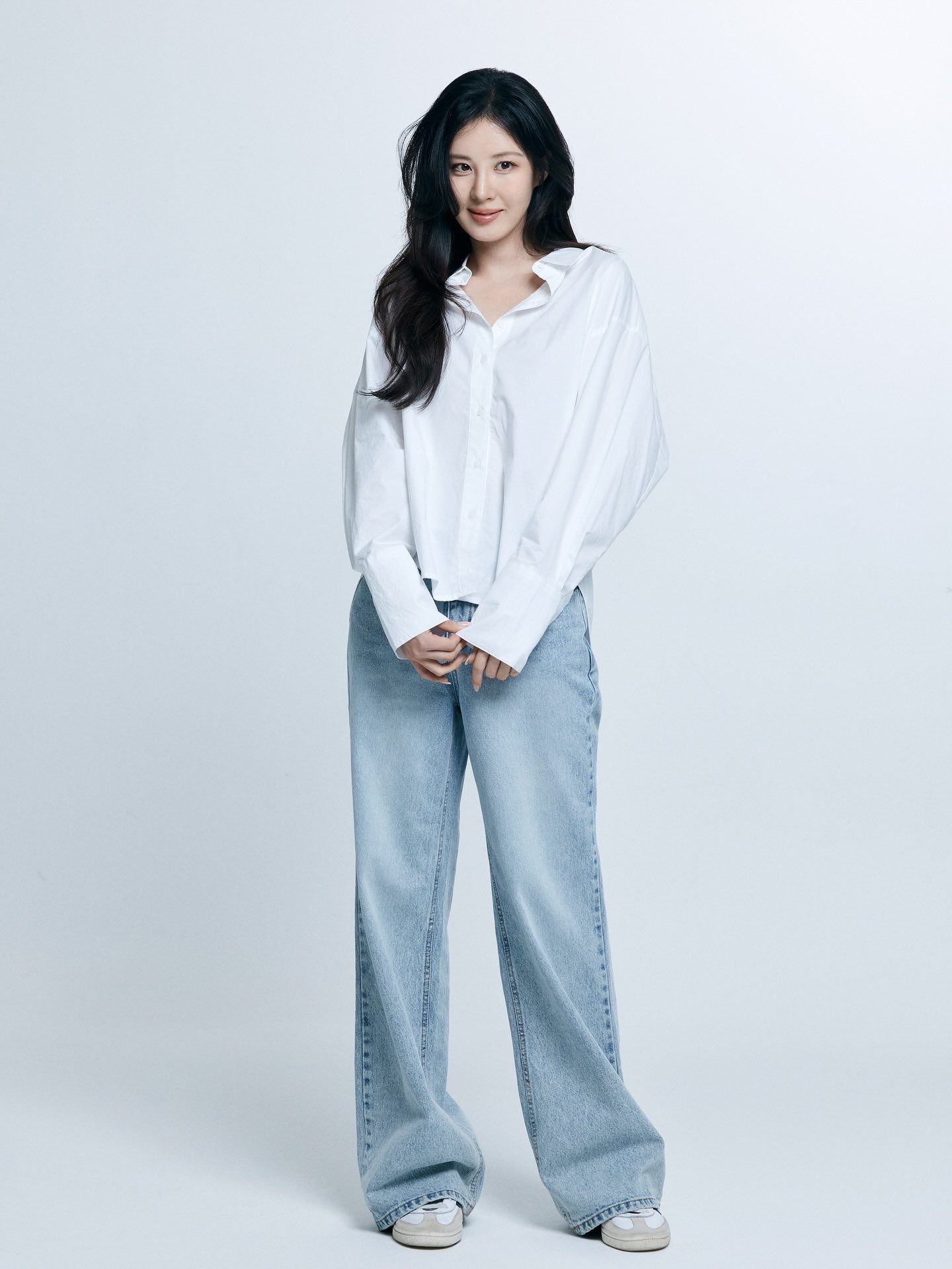 Seohyun with radiant skin and minimalist makeup in a white shirt, exuding elegance.