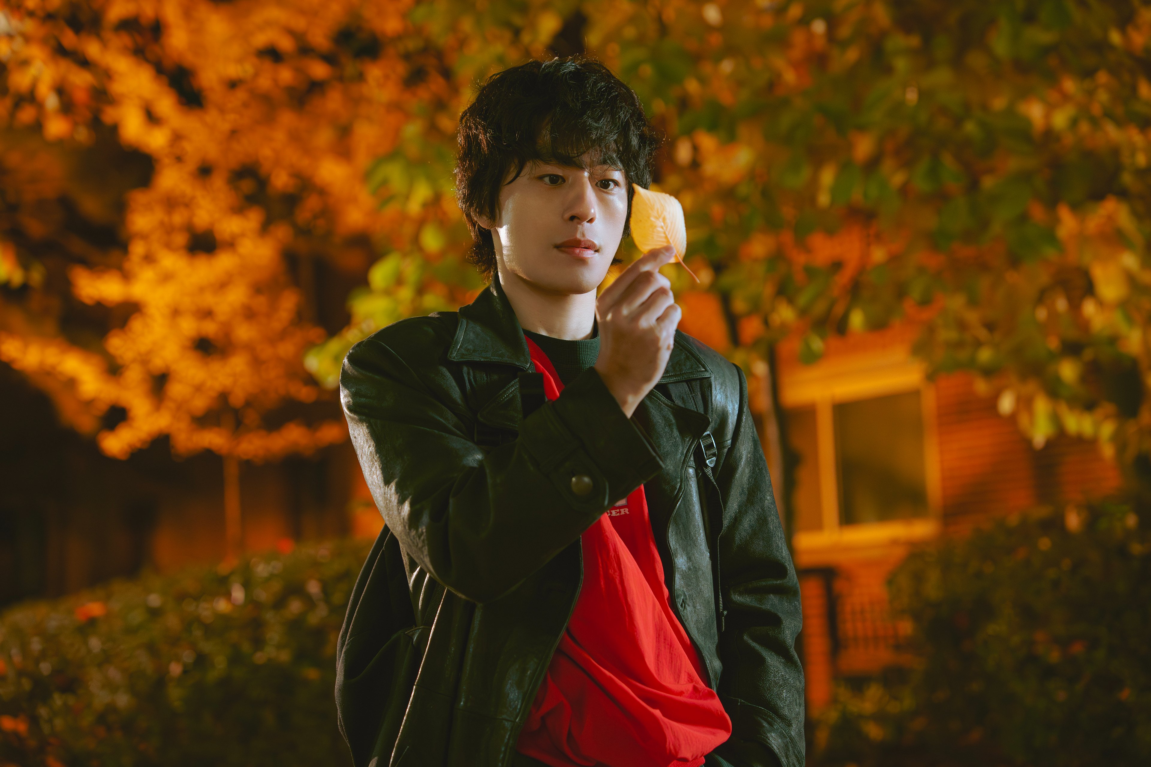 Koo Kyo Hwan as Hwang Dong Man, caught in a moment of playful eccentricity, possibly trying to catch leaves.